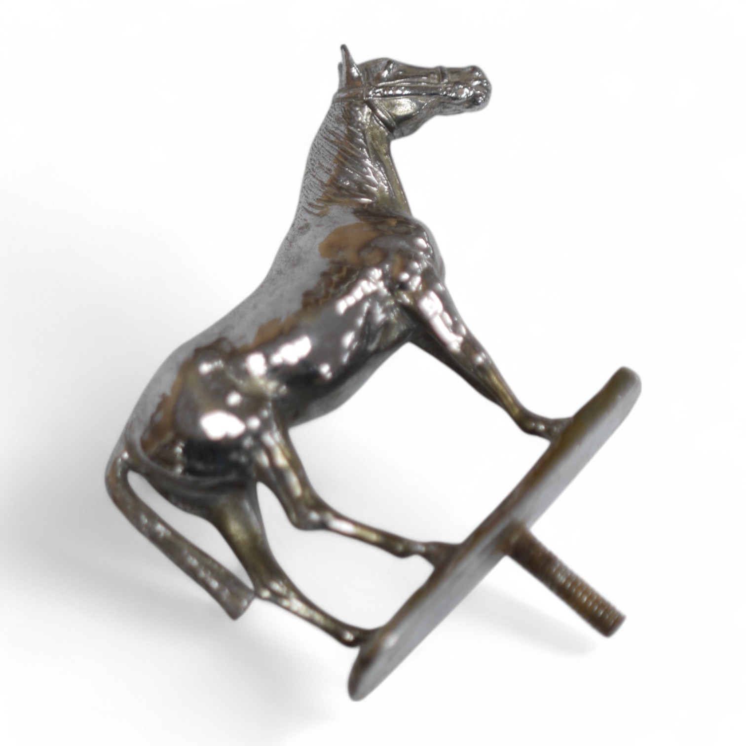 A silvered bronze ‘horse’ car mascot, 12cm wide. Condition - good